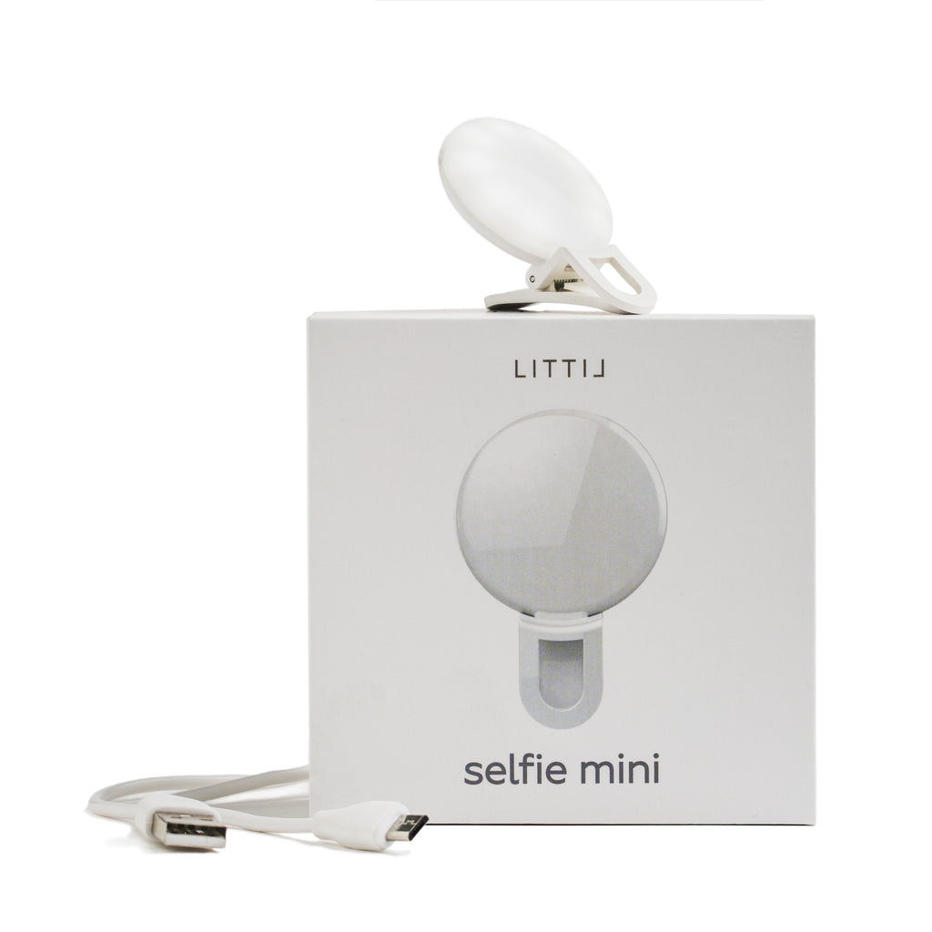 LITTIL Selfie Mini with product box and charging cable on a white background. 